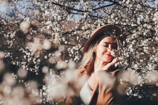 Woman in dress smelling flowers