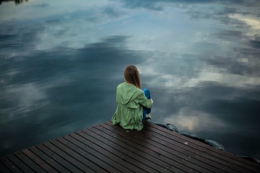 Woman sitting on a wooden dock