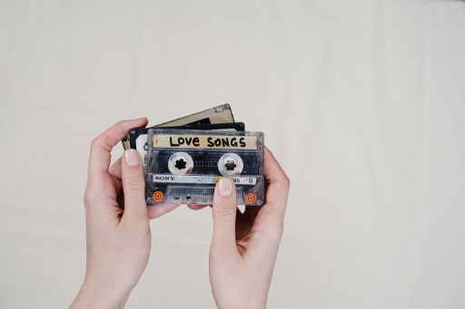 person holding cassette tapes