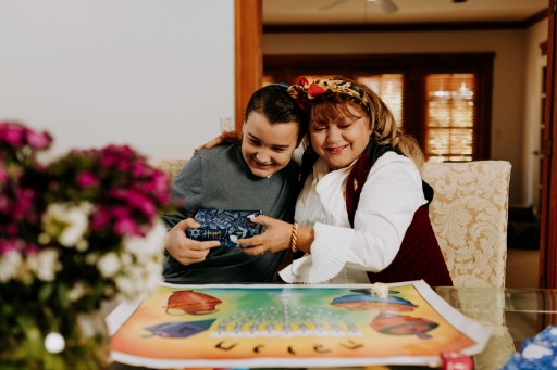 Mother handing gift to son