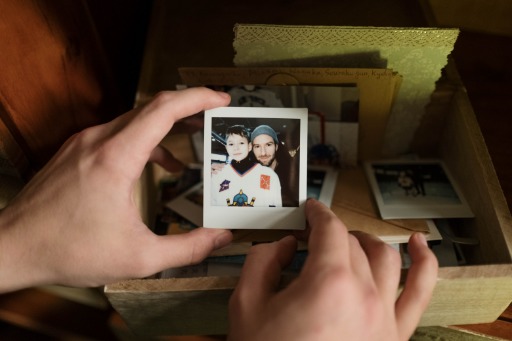 person holding photographs