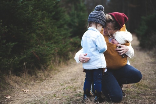 woman holding son in grass