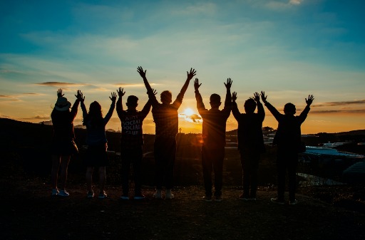 People jumping during a sunset