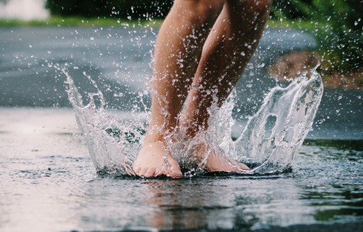 People dancing in a puddle