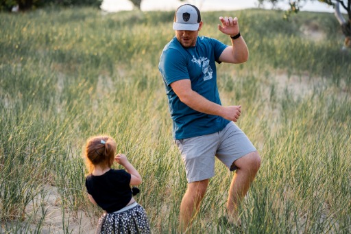 father playing with son in field